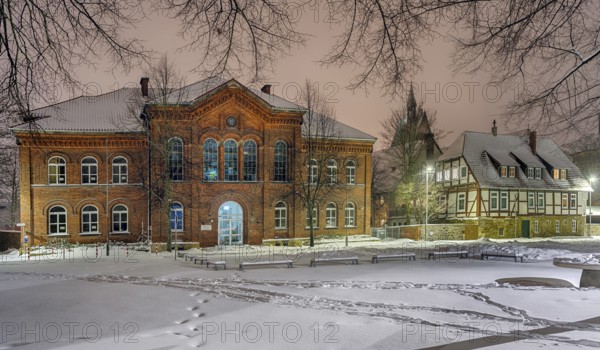 IGS and old Latin school illuminated by winter snow Stadthagen Germany