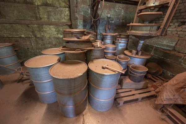 Metal drums for metal powder in the bronze powder filling room of a metal powder mill, founded in