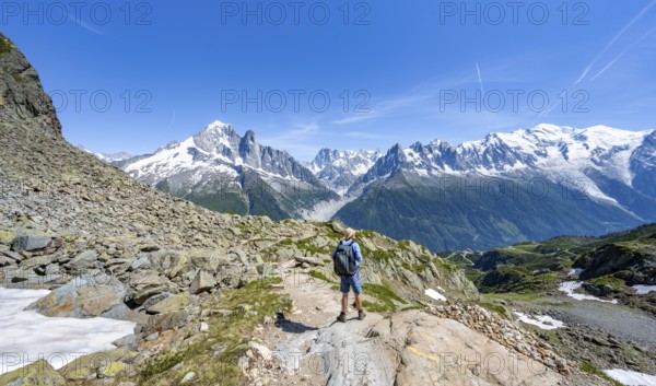 Mountaineers on a hiking trail in front of a mountain landscape, view of mountain peaks Aiguille