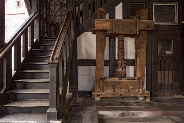 Market hall, old town hall, stairs to the upper floor, wooden cloth press with threaded screw by