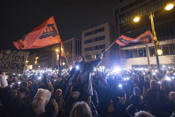 Sea of lights with flags Revolution at the demonstration under the motto Brandmauer statt