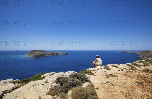 Hikers on the way to the cape of the Gramvousa peninsula with a view of the island of Imeri
