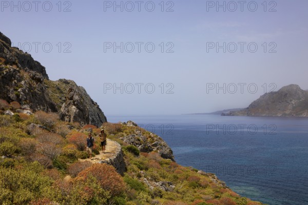 Hikers on the Sarella peninsula near Plakias, south coast, Crete, Greece, Europe