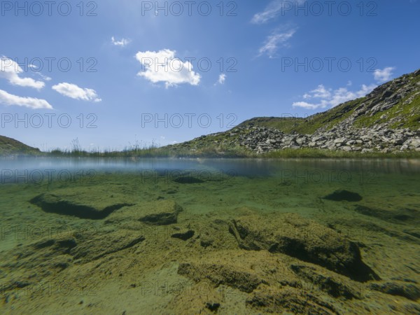 Clear mountain landscape with underwater view and sunny sky, Neukirchen am Großvenediger, Salzburg,