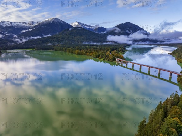 Snow-covered mountains reflected in lake, sunny, bridge, autumn, Sylvensteinsee, Karwendel