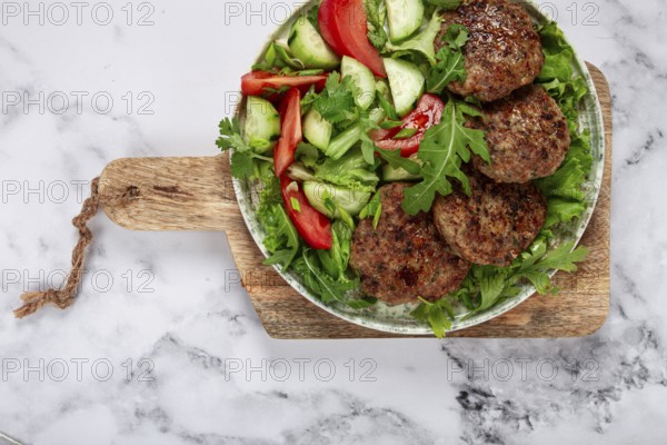 Fried cutlets, mixed minced meat, with vegetable salad, homemade, top view, no people