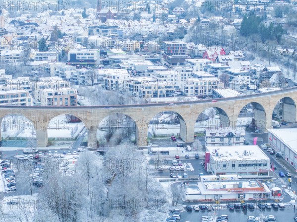 Townscape with snow-covered viaduct and houses in a winter landscape, Nagold, Black Forest,