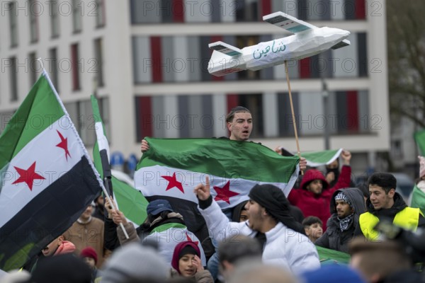 People celebrate the end of the Assad regime after the change of power in Syria at a rally on the