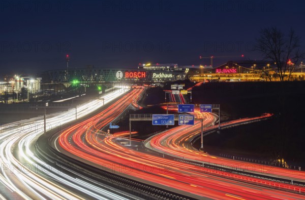 A8 motorway at Stuttgart Airport in the evening. Heavy traffic, lanes of light. Modern architecture