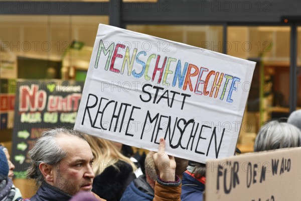 Heidelberg, Germany - February 12th 2025: Person holding up sign with text 'Human rights instead of