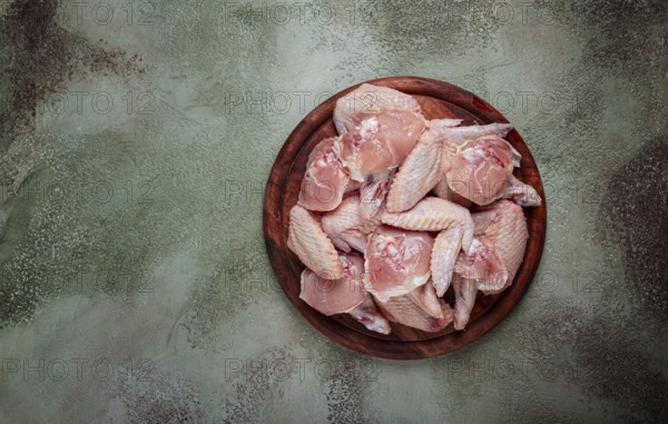 Raw chicken wings, on a wooden board, top view, no people