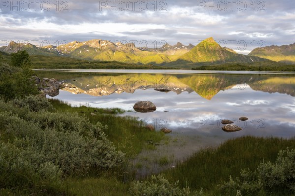 Mountains reflected in the sea, near Laukvik, Austvågøya, Lofoten, Norway, Europe