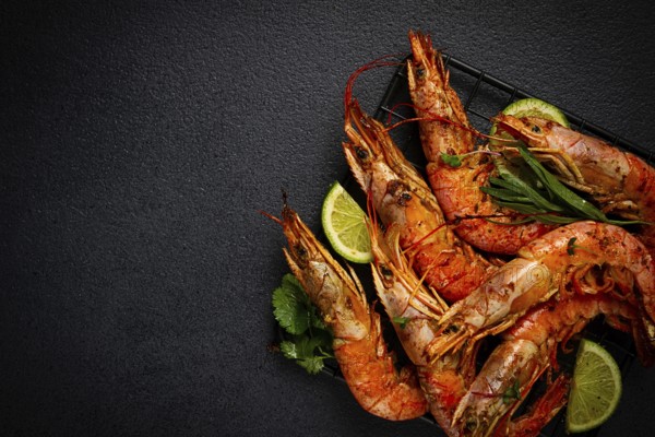 Langoustines, Australian, freshly frozen on ice, top view, lime and greens