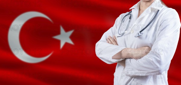 Doctor with crossed arms on Turkey flag. Turkey Health and Care concept. Female doctor on Turkey