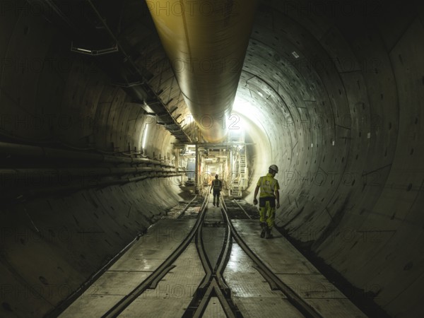 Workers in a tunnel section at the double-shield tunnel boring machine in section H53 of the