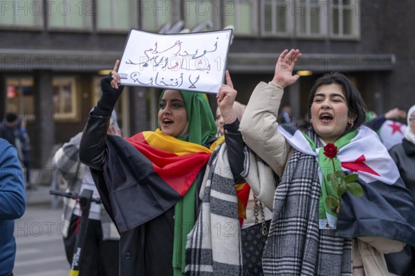 Syrian woman celebrate the end of the Assad regime after the change of power in Syria at a rally on