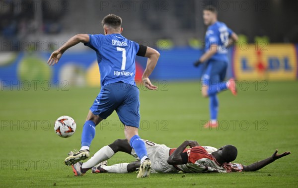 Duel, action Sael Kumbedi Olympique Lyon Lyonnais OL (20) on the ground against Tom Bischof TSG