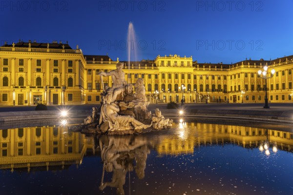 Fountain in the courtyard of honour at Schönbrunn Palace at dusk, UNESCO World Heritage Site in