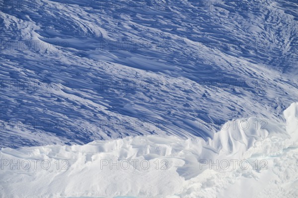 Snow-covered landscape with layers of ice and blue tones, impressive texture and natural cold, snow