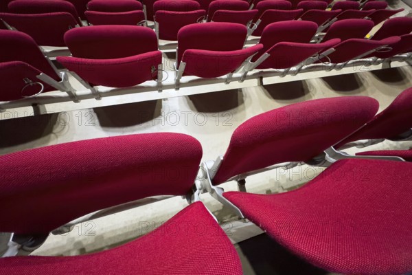 Empty folded-up seats Folding chairs with backrests in rows of seats mounted next to each other