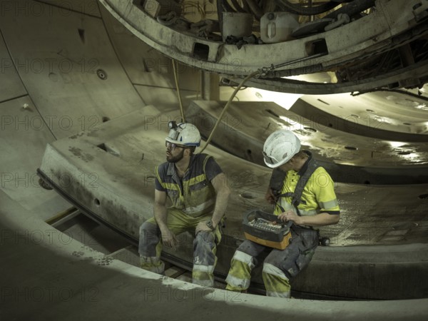 Workers in a tunnel section at the double-shield tunnel boring machine in section H53 of the