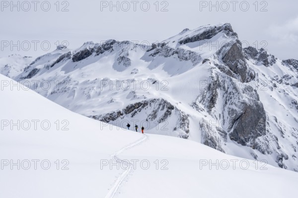 Three lonely ski tourers, winter in the Bernese Alps, Bernese Oberland, Switzerland, Europe