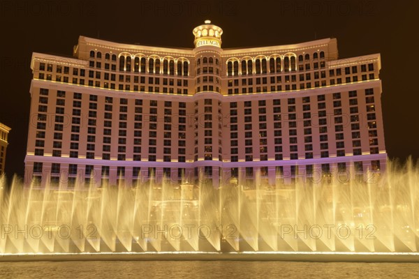 Illuminated Bellagio Hotel with water fountains in front of it at night, Las Vegas, Nevada, USA,