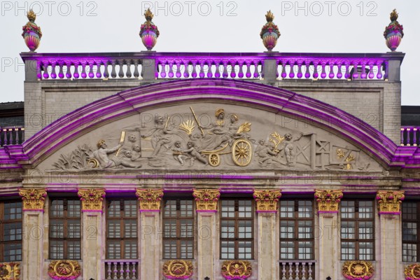The illuminated gable of the guildhall Le Moulin à Vent and Pot d'Étain in the evening,