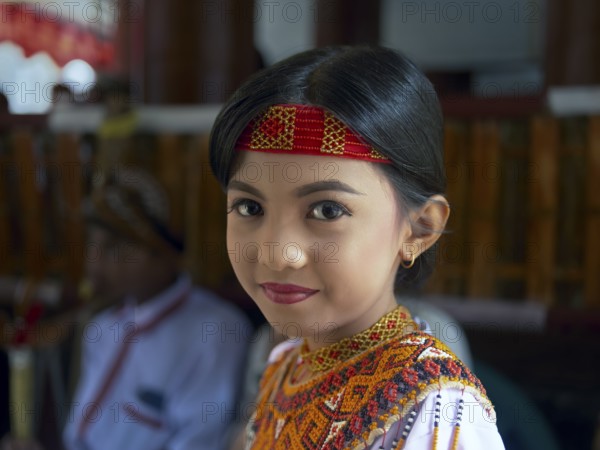Toraja girl in traditional colourful clothing, portrait, Tana Toraja, Rantepao, Sulawesi,