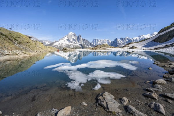 Mountain landscape with mountain lake and ice floe, water reflection in Lac Blanc, mountain peak,
