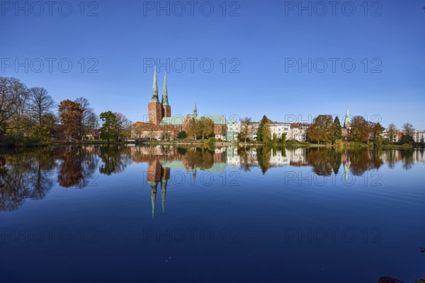 Long shot of the mill pond, trees, Lübeck Cathedral, general buildings, symmetrical reflections on
