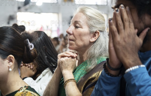 Devotees pray in church during a Christmas day sermon on December 25, 2024 in Guwahati, India.