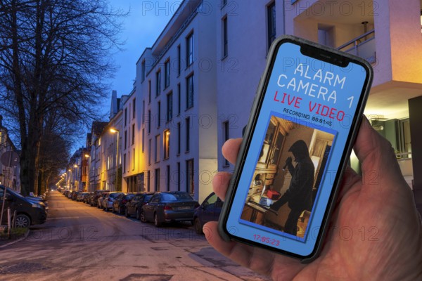 Symbolic image of burglary, burglary video app, shows the live image from a flat while a burglar is
