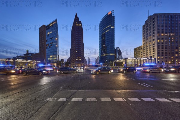 Police operation with blue light, vehicles with motion blur, skyscrapers Forum Tower, Kollhoff