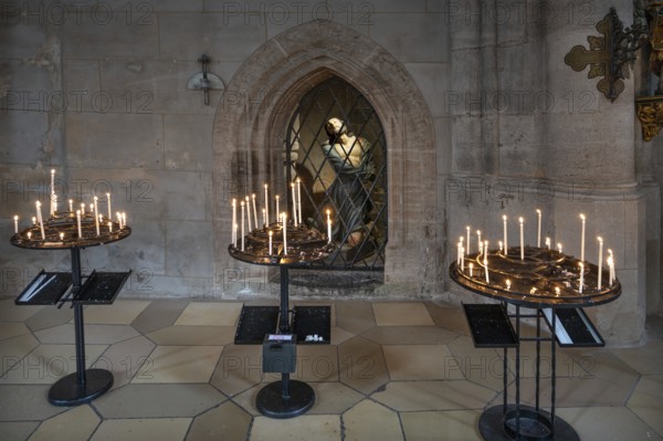 Sacrificial candles, a figure of Jesus at the back in the late Gothic hall church of St George,