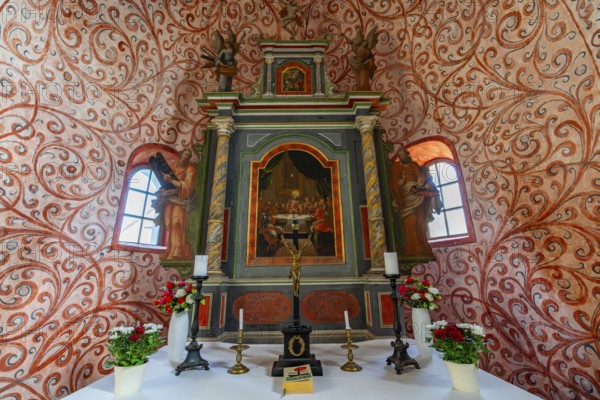 Interior and altar, walls with colourful frescoes in the Romanesque fieldstone church in the