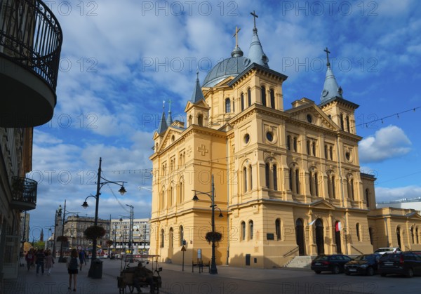 Imposing church with neoclassical façade and towers, located in the city centre with pedestrian