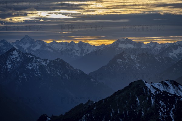 Mountain panorama with snow at sunset, in autumn, view from Kramerspitz, Bavarian Prealps, Bavaria,