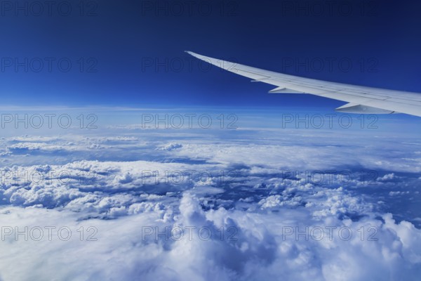 View from the aircraft window during a flight over India with the airline Etihad. Blue sky and