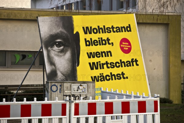 Large FDP election poster with Christian Lindner for the 2025 Bundestag election behind a barrier,
