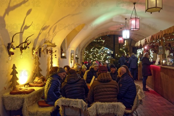 Town hall, vault, restaurant, cosy, visitors sit together, illuminated, lights, Advent season,