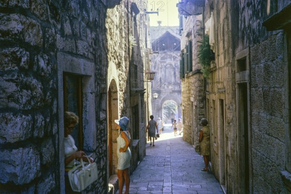 People in narrow alleyway street of the old town, Korcula, Croatia, former Yugoslavia, Europe 1970,