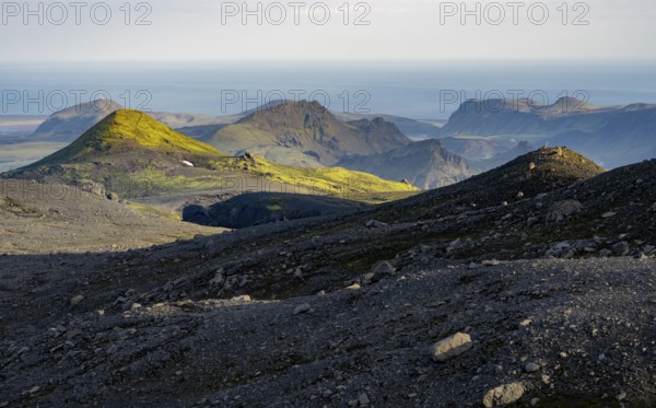 Volcanic mountain landscape overgrown with moss, atmospheric mountain landscape in the evening