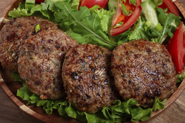 Fried cutlets, mixed minced meat, with vegetable salad, homemade, top view, no people