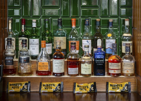 Bottles of different whisky brands, Crown Hotel pub in city centre of Liverpool, England, UK