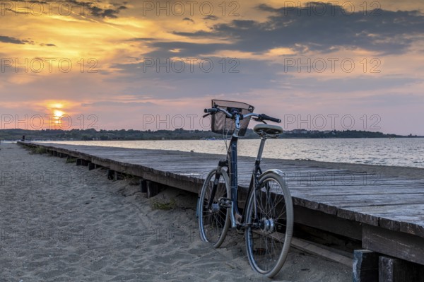 Bicycle at the jetty with orange sunset at the sea, calm evening mood, Nin, Zadar, Croatia, Europe