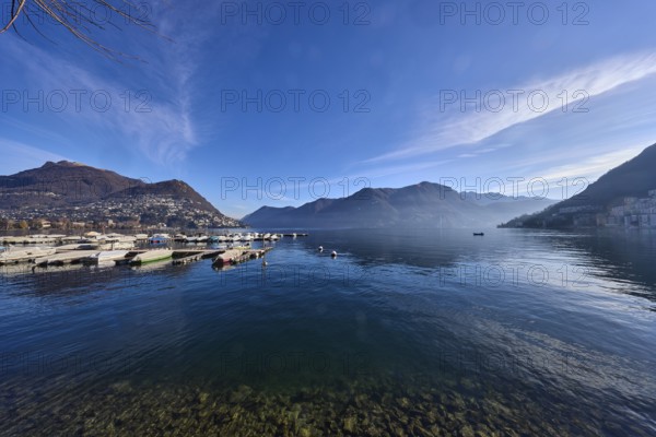 Lake, marina, jetties, motorboats, mountains, haze, blue sky, cirrostratus clouds, Lake Lugano,