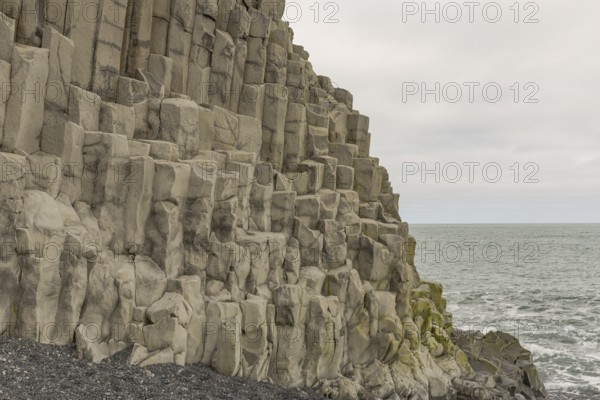 Reynisfjara Beach with Basalt rocks (Stuolabrrg) and the rock needles (Haidrangur), close to Vik i