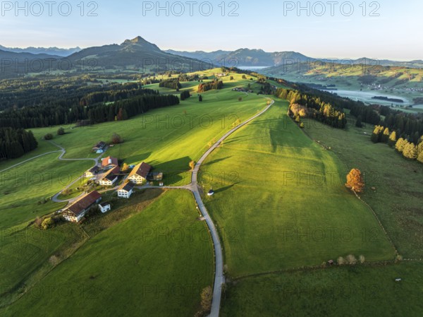 Mountain range near village Wertach, view to mt. Gruenten, sunrise, fog in valley, autumn colors,