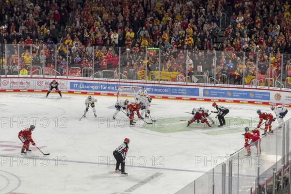 Players and referee in line-up for face-off during ice hockey in multifunctional hall, in the